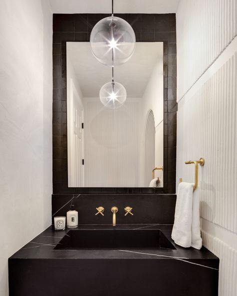 Haus of Design on Instagram: “The black countertop and tiled mirror really make the brass fixtures pop 💥 #hausofdesign” Black Tile Behind Vanity, Backsplash Powder Room, Tile Behind Vanity, Black Tile Backsplash, Tiled Mirror, Black Countertop, Black Tile, Brass Fixtures, Black Tiles