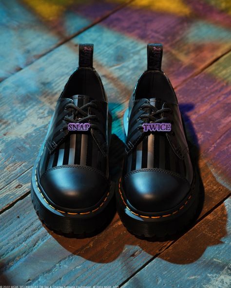 Shoe of the Day: @drmartensofficial x Wednesday 1461 Bex Wednesday Shoe. ⁠ ⁠ Just in time for spooky season, Dr. Martens is launching its first collaboration with @wednesdaynetflix. The line is inspired by the iconic Addams family character, played by Jenna Ortega in the hit TV series produced by MGM Television for Netflix. ⁠ ⁠ This style is made with smooth leather, a gloss stripe print, and a plain toe cap with stitch detailing. Purple accent details are throughout the shoe, including in th... Addams Family Characters, Purple Accents, Addams Family, Boot Socks, Jenna Ortega, Just In Time, Dr. Martens, Spooky Season, Stripe Print