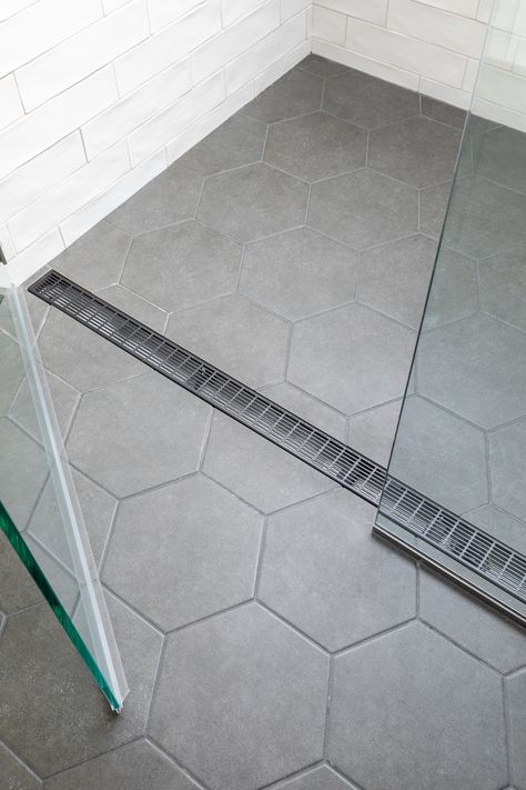 Tiled Bathroom Floors And Showers, Small Grey Hexagon Tile Bathroom, Continuous Bathroom Shower Floor, Seamless Bathroom Shower Floor, Walk In Shower With Hexagon Tile, Big Tile In Shower Floor, Hexagon Tile Shower Wall Tilebar, Large Tile For Shower Floor, Light Gray Hexagon Tile Bathroom