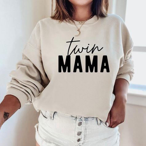 "The \"Twin Mama Sweatshirt\" is a sturdy and warm crewneck sweatshirt bound to keep you warm in the colder months. These cozy sweatshirts make a great gift for anyone! A pre-shrunk, classic fit sweater that's made with air-jet spun yarn for a soft feel and reduced pilling. Sweatshirt details: * 50% cotton, 50% polyester * Pre-shrunk * Classic fit with no center crease * 1x1 athletic rib knit collar with spandex * Air-jet spun yarn with a soft feel and reduced pilling * Double-needle stitched co Custom Crewneck Sweatshirts, Sweatshirt Details, Grandma Sweater, Mom Sweater, Gildan Sweatshirt, Nurse Sweatshirt, Hoodie Brands, Mama Gifts, Mama Sweatshirt