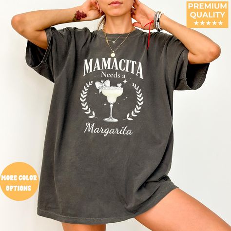 Mamacita Needs a Margarita Funny Tequila Shirt, Tequila Shirt, Tequila Lover Shirt, Tequila Gift, Drinking Shirts, Margarita Shirt Add some fun to your wardrobe with this Mamacita Needs a Margarita shirt! Perfect for tequila lovers, party-goers, and margarita enthusiasts, this comfy tee is a must-have for any fun night out or casual day. Makes a great gift for birthdays, bachelorette parties, or any celebration! 🍹 ✔ Soft & Comfortable: Made from high-quality fabric for all-day comfort ✔ Unique Design: Fun and trendy print that stands out Sizing Note for XL and Up: For sizes XL and above, Comfort Colors® shirts have a relaxed, generous fit that may run slightly larger than expected. If you're looking for a more fitted look, consider sizing down. We've included detailed measurements for eac Tequila Humor, Tequila Gift, Margarita Shirt, Funny Drinking Shirts, Tequila Shirt, Drinking Shirts, Trendy Prints, Bachelorette Parties, Party Shirts