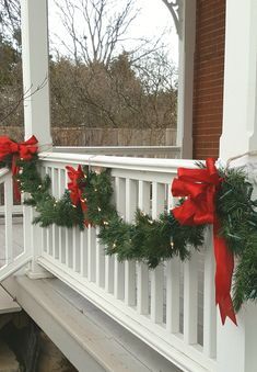 Garland Front Porch Railing, Christmas Porch Decor Garland, Porch Banister Christmas Decor, Porch Railing Christmas Decorations, Garland On Outdoor Railing, Outdoor Christmas Garland Porch, Christmas Porch Garland Ideas, Outside Garland Christmas Porch Ideas, Christmas Garland Outdoor Front Porches