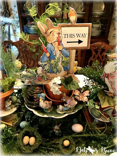 Beatrix Potter Easter Hunt in Mr. McGregor’s Garden. See this over the top Easter tablescape and centerpiece with classic figurines, and seasonal décor and tableware. #tablescape #tablesetting #eastertable #beatrixpotter Beatrix Potter Tea Party, Peter Rabbit Easter Decor, Peter Rabbit Table Decor, Peter Rabbit Tablescape, Peter Rabbit Table Decorations, Beatrix Potter Theme Party, Peter Rabbit Tea Party, Beatrix Potter Party, Me Mcgregors Garden