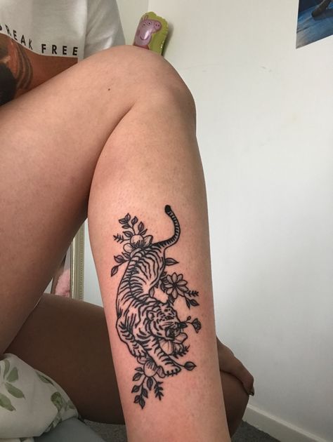 Tiger Tattoo On Leg For Women, Tiger With Lily Tattoo, Cheetah Tattoo Leg, Cat Spine Tattoo, Tiger Tattoo Flowers, Tiger Ankle Tattoo, Tiger With Cherry Blossom Tattoo, Tiger Calf Tattoo, Flower Tiger Tattoo