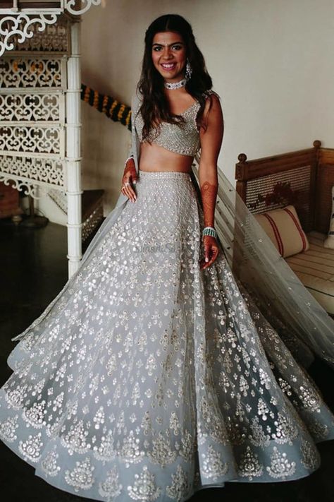 We absolutely love how her Bridal Glow looks more radiant in that Silver Lehenga. If You looking for Trendy Bridal Lehenga, We have complied a great collection of Silver Bridal Lehenga to take inspiration from. Check them all out in the link attached below.    #indianwedding #shaadisaga #intimatewedding #bridallehenga #bridalfashion #offbeatlehenga #uniquelehenga #indianbridaltrends #indianweddingtrends #silverlehenga #greylehenga #embellishedlehenga #sequinlehenga Silver Lehenga, भारतीय दुल्हन संबंधी, डिजाइनर कपड़े, Nikkah Dress, Indian Outfits Lehenga, Perhiasan India, Lehnga Dress, Designer Bridal Lehenga, Indian Bridal Lehenga