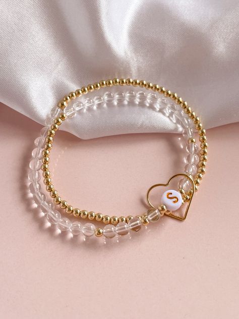 Create a truly one-of-a-kind gift with our WRAPPED IN LOVE bracelet. A light weight, double wrapped bracelet, all encircled in a large heart charm, this piece is a stunner! Customize and personalize with your choice of gemstone, meaningful initials or graphic beads for a special touch. Perfect for Mother's Day or any special occasion. Express your love with this unique and special bracelet. This listing is for ONE Customizable Double-Wrapped Bracelet in 3mm STERLING SILVER, 4mm Gemstone Letter Bead Stretch bracelet, with Large open Heart Charm.All other photos are examples for how the bracelet can be paired with other pieces.All bracelets are handmade with strong elastic cord. SIZING:Please measure your wrist to ensure you get the proper size bracelet.For a snug fit, add 1/2 inch to your w Letter Bead Bracelets, Large Heart, Love Bracelet, Letter Beads, Bracelet Crafts, Open Heart, Beaded Stretch Bracelet, Love Bracelets, Pouch Bag