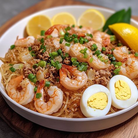 🍜 "Dive into the deliciousness of Pancit Luglug—a Filipino noodle dish that’s full of flavor and tradition!" 🍜🇵🇭 #PancitLuglug #FilipinoFood Pancit Luglug Ingredients: Rice noodles (0.5 lb) Shrimp, peeled and deveined (0.5 lb) Ground pork (0.25 lb) Garlic, minced (4 cloves) Onion, chopped (1) Annatto seeds (2 tbsp, soaked in water) Fish sauce (2 tbsp) Shrimp broth (2 cups) Hard-boiled eggs, sliced (2) Chicharron, crushed (0.5 cup) Green onions, chopped (for garnish) Lemon or calamansi wedg... Pancit Luglug, Shrimp Broth, Filipino Noodles, Annatto Seeds, Cozy Fall Recipes, Noodle Dish, Festive Drinks, Noodle Dishes, Hearty Soups