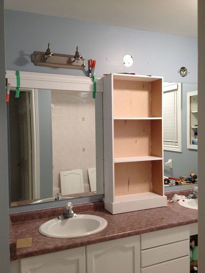 large bathroom mirror redo to double framed mirrors and cabinet, bathroom ideas, home decor, shelving ideas, middle cabinet in place new light fixtures connected and now onto the framing of the mirrors Large Bathroom Mirror, Makeover Kamar Mandi, Large Bathroom Mirrors, Shelves Bathroom, Diy Bathroom Vanity, Framed Mirrors, Mirror Makeover, Double Sinks, Large Bathroom