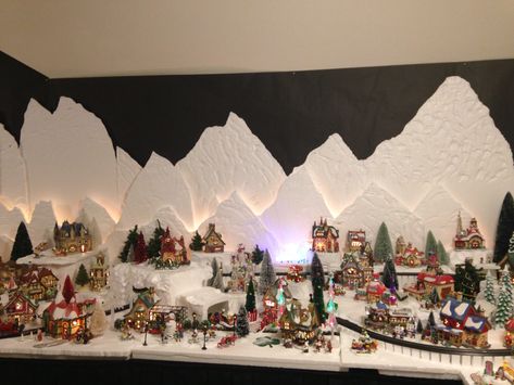 Christmas Village- North Pole.  I carved the mountains with a hotwire foam factory tool out of styrofoam.  I mounted extra village lights between the sheets to add dimension and a light effect. 2015 North Pole. Christmas Village Display Ideas, Village Display Ideas, Diy Christmas Village Displays, Christmas Tree Village Display, Christmas Tree Village, Lemax Christmas Village, Christmas Village Sets, Lemax Christmas, Diy Christmas Village