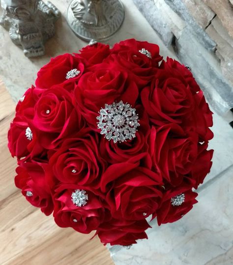 You will Love this Lush Broche Bouquet! It has 22 Beautiful Velvety soft Apple Red Roses accented with Silver Crystals that Sparkle throughout the Bouquet.  The base has soft Lamb's ear leaves with a White lace handle finished with a Silver Rhinestone wrap, Black glitter band and Silver Rhinest Red And Silver Bouquet, Red Silver Wedding, Quince Decor, Black And Red Roses, Silver Wedding Decorations, Red Rose Bouquet, Quince, Black Glitter, Red Apple