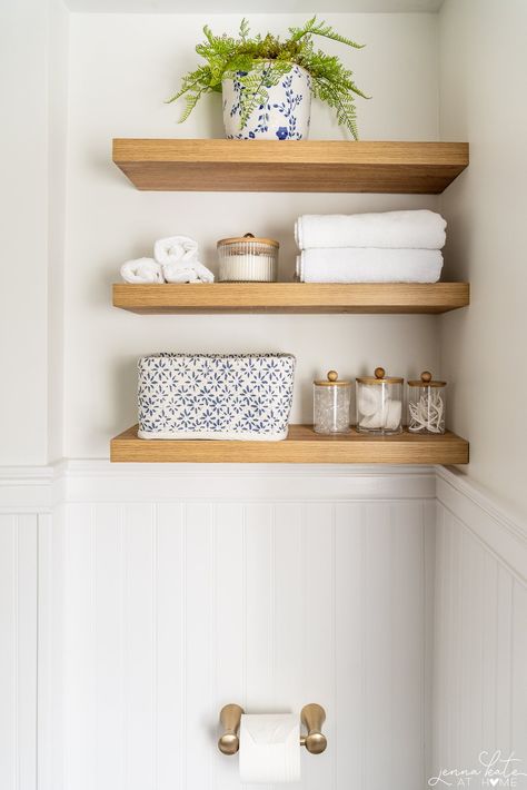 Beachy Bathroom Shelves, Toilet Room Floating Shelves, Natural Wood Floating Shelves Bathroom, Simple Room Renovation Ideas, Shelf In Bathroom Above Toilet, Floating Wood Shelves Bathroom, Floating Shelf Bathroom Decor, Small Bathroom Floating Shelves, Wood Shelves Above Toilet