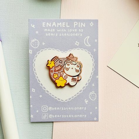 The cutest little astronaut bear pin suspended amongst the stars! ✧ ✧ D E T A I L S:  - Hard enamel pin with rose-gold plating! - Approx. 0.99 in. x 1 in. (25.3mm x 25.4 mm) in size - Back stamped with logo for authenticity! - Pins will come on a backing card in a cello sleeve - Color may vary due to different screen monitors ✧ C H O I C E S: A-Grade ♡ The highest quality offered, but due to the handmade nature of the product, it may have minor imperfections such as, but not limited to:  -Light scruffs, scratches, smudges, buff marks -Small dents -Slight discoloration -Low/over filled enamel in small areas -Small bubbles, dust specks, dots, fuzz, etc in enamel  B-Grade ♡ These pins may have more noticeable flaws, but are still great for everyday wear! They will be sold at a slight discount Enamel Pin Backing Card Design, Enamel Pin Backing Card, Pin Backing Card Design, Pin Backing Card, Astronaut Bear, Cute Enamel Pins, Cute Astronaut, Enamel Pin Collection, Pin Cute