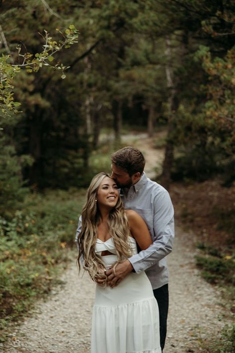 Montana Engagement Photos in GNP | Glacier Park Photographer | Playful couples photos. Ready to capture those special moments leading up to your big day? Discover our amazing Engagement Guide filled with fun ideas. See country couple aesthetic photos, country couple photos, unique engagement photos locations and modern western engagement pictures. Book Brogan to capture your country engagement at photographybybrogan.com. Wood Engagement Pictures, Engagement Photos Trees, Country Couple Aesthetic, Field Engagement Pictures, Country Couple Photos, Western Engagement Pictures, Engagement Photos Locations, Country Couple, Western Engagement