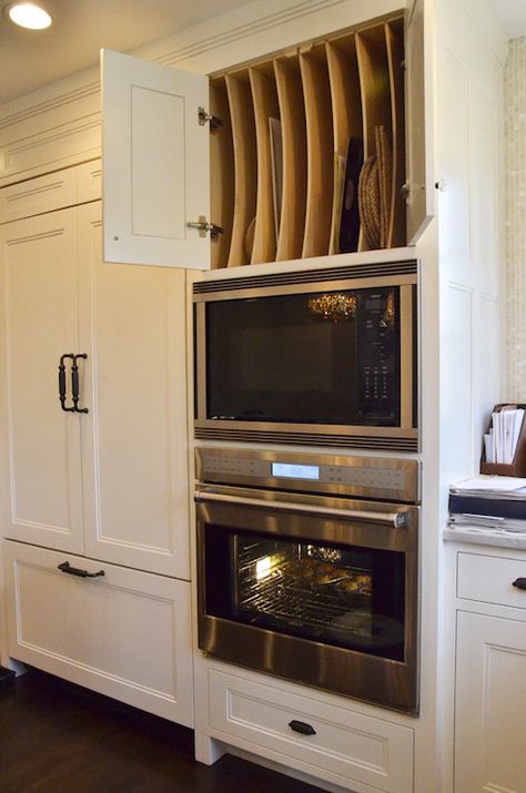 Stunning shaker kitchen features cabinet front fridge with freezer drawers alongside a stainless steel wall oven under an integrated microwave and custom baking cabinet above filled with vertical tray shelves. Serveware Storage, Kitchen New York, Cookie Sheets, Kitchen Hacks Organization, Shaker Kitchen, Trendy Kitchen, Kitchen Redo, Traditional Kitchen, Kitchen Remodel Idea