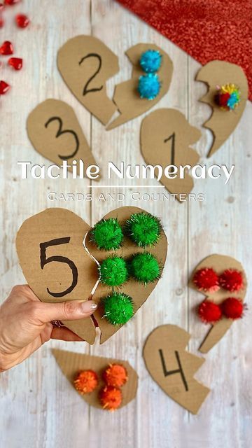 Montessori Homeschool Made Easy on Instagram: "💕Tactile Numbers and Counters 📦DIY🧩 Puzzle 𝒇𝒐𝒍𝒍𝒐𝒘 @MontessoriFromTheHeart ♡ for more! ▫️▫️▫️▫️ ♥️Like this post of you want to see more of similar ideas! ⠀ Here is a Valentine’s inspired ✋🏻tactile numeracy 🧩DIY you must try! ⠀ INSTRUCTIONS: -✂️cut a 📦 cardboard into ❤️shapes - then cut each ❤️into halves - write a numeral on one side and hot glue the corresponding quantity of pom poms to the other ⠀ 🙌🏻Offer your child to solve the puzz Counting Montessori Activities, Shape Sensory For Toddlers, Montessori Puzzle Ball, Number Puzzle 1-5, Number Beads Montessori, Similar Ideas, Math Activities For Toddlers, Montessori Math Activities, Solve The Puzzle