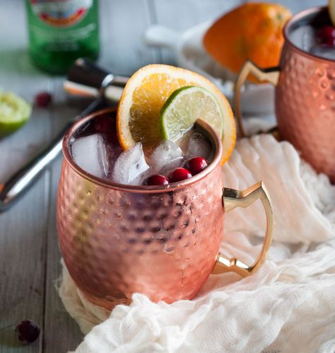 Cranberry Moscow mule recipe made with zesty orange, zippy ginger beer, vodka, lime, and cranberry just might be the most refreshing drink on the planet. Try one today! Cranberry Moscow Mule Recipe, Cranberry Moscow Mule, Orange Juice And Vodka, Moscow Mule Recipe, Vodka Lime, Mule Recipe, Bar Party, Brass Handle, Moscow Mule