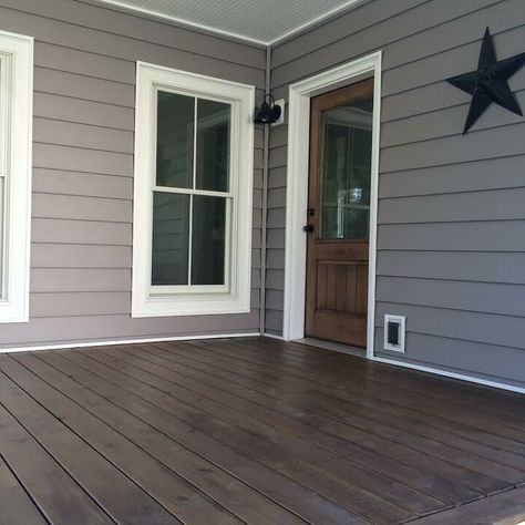 Why pay a professional when you can do it yourself? With some time and elbow grease, we were able to save a couple of hundred dollars by staining our entire covered front porch ourselves! It definitely was a project, but one that was worth it! By using a can of outdoor stain, we completely transformed the look and feel of our entire porch! This was an all day project but the reward was worth it! We used Behr semi transparant stain that we picked up from our local Home Depot. The st… Stained Front Porch, Porch Stain, Front Porch Remodel, Deck Stain Colors, Stain Concrete, Deck Stain, Porch Kits, Fence Stain, Diy Staining