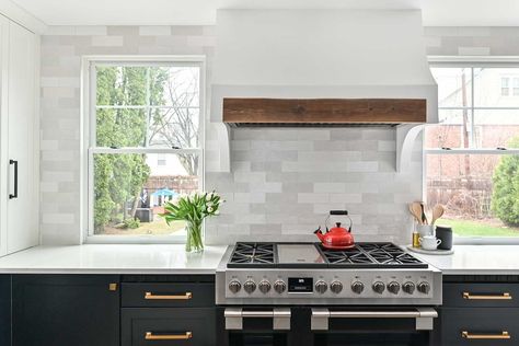 Custom Hood – Sitting between the two windows, the focal point in this kitchen is the plaster hood with barnwood detail and curvy sides. Kitchen Range Hood Between Windows, Kitchen Range Between Two Windows, Shiplap Stove Hood, Windows Behind Stove, Kitchen Hood Between Windows, Range Wall With Windows, Vent Hood Between Windows, Stove With Windows On Each Side, Stove Between Two Windows