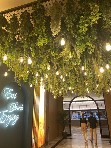 Faux Plant Ceiling, Hanging Plant Ceiling, Greenery On Ceiling, Ceiling With Plants, Plant Ceiling Decor, Jungle Ceiling, Greenery Restaurant, Diy Ceiling Decor, Foliage Ceiling