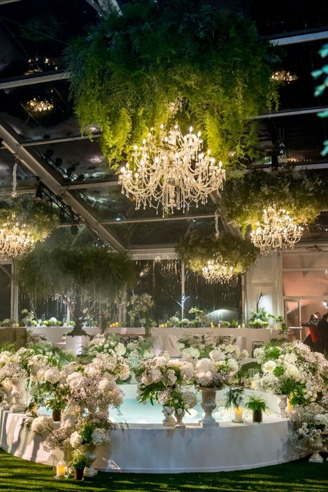 Romantic setting with crystal chandeliers and lush greenery, bringing a garden-like feel to this elegant indoor reception. Chandelier Greenery, Indoor Reception, Crystal Chandeliers, Lush Greenery, Greenery Wedding, Design Floral, Crystal Chandelier, Chandeliers, Wedding Reception