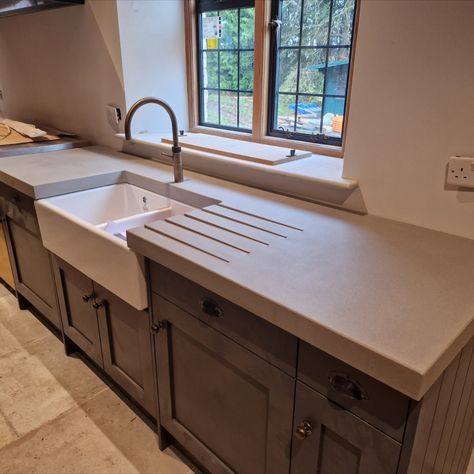 Looking for a stylish and long-lasting countertop solution for your kitchen? Our custom-made concrete countertops are not only visually stunning but also built to last. See our latest project featuring these beautiful countertops in a stunning single-family home. With easy maintenance and a sleek modern design, our concrete countertops are the perfect upgrade for any kitchen.

#concretecountertops #kitchendesign #homedecor #interiordesign #kitchenremodel #concretedesign #modernkitchen Small Kitchen Concrete Countertops, Concrete Shelves Kitchen, Tan Concrete Countertops, Polished Concrete Kitchen Countertops, Kitchen Cement Countertops, Light Concrete Countertops, Concrete Worktop Kitchen, Cement Countertops Kitchen, Kitchens With Concrete Countertops