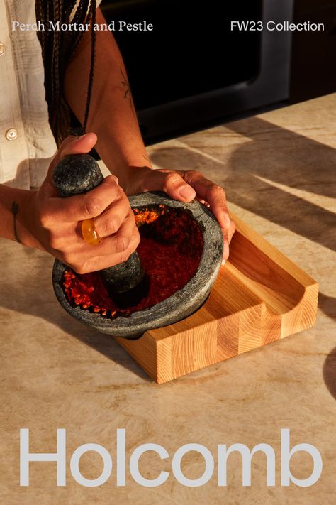 Reminiscent of an heirloom kitchen tool, the heavy, textured granite stone of our Perch Mortar and Pestle makes quick work of pestos, curries, and whole dried spices. Our Perch Mortar and Pestle rests in an architectural base that allows you to position the mortar at the ideal angle, providing additional leverage and protecting countertops from the rough stone. The natural ash wood wears with use, ensuring the mortar nests even more smoothly with time. Heirloom Kitchen, Dried Spices, Product Inspiration, Sound Dampening, Granite Stone, Salt Cellar, Bath Storage, Kids Kitchen, Candle Accessories