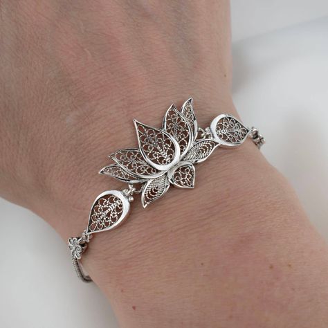 Embrace elegance with every gesture 🌸 Our Lotus Flower Sterling Silver Bracelet is the epitome of grace and handcrafted beauty, perfect for commemorating unforgettable moments. Whether you're seeking a memorable anniversary gift or simply want to add a touch of filigree art to your style, this adjustable charm bracelet is sure to captivate. Click the link to adorn your wrist with this exquisite piece or to gift an everlasting bloom to the one you adore. 🎁✨ #SterlingSophistication #Anniversary... Lotus Motif, Lotus Flower Jewelry, Silver Bracelet Designs, Silver Bracelet For Women, Flower Woman, Lotus Bracelet, Lotus Jewelry, Jewellery Design Sketches, Bracelets Design