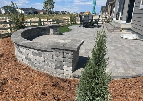 Excellent look and unique design to this backyard paver patio with a sitting wall. Great for entertaining Paver Patio With Retaining Wall, Fire Pit Ideas Backyard Square, Sitting Wall Patio, Paver Patio With Steps, Paver Patio Ideas On A Budget, Rock Pavers, Sitting Wall, Backyard Retaining Walls, Outdoor Pavers