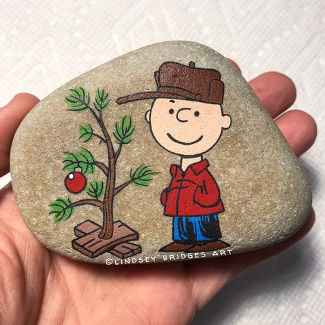 Charlie Brown Christmas painted rock  by Lindsey Bridges   #christmas #paintedrock #rockpainting #charliebrownchristmas #charliebrownrock #paintedstone #stonepainting #rockart #artrock #stoneart Christmas Rock Painting Ideas, Christmas Rock Painting, Painting Christmas, Rock Painting Ideas, Christmas Crafts To Make, Christmas Rock, Rock And Pebbles, Painted Rocks Diy, Rock Painting Ideas Easy