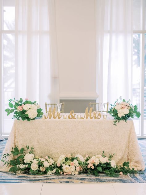 Timeless Romantic Sweetheart Table with Ivory Floral Linen, Lush Greenery and White, Blush Pink Roses and Hydrangeas, Gold Mr and Mrs Table Sign, Chiavari Chairs | Tampa Bay Wedding Planner Special Moments Event Planning | Wedding Rentals Kate Ryan Event Rentals | Wedding Venue Hyatt Regency Clearwater Beach Wedding Floral Arrangements Sweetheart Table, Blush Pink Sweetheart Table, Couple Head Table Wedding, Sweetheart Table With Sign, Sweetheart Table Wedding Mr And Mrs Sign, Bride And Groom Table Decorations Simple, Wedding Decor Sweetheart Table, Rectangular Sweetheart Table Wedding, Sweet Heart Table Flower Arrangement