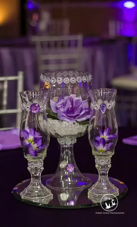 50+ Stunning DIY Dollar Store Wedding Centerpieces - Holidappy Quinceanera Centerpieces Purple, Wedding Table Centerpieces Vases, Purple Centerpieces Quinceanera, Wine Glass Candle Lamps, Centerpieces With Wine Glasses, Elegant Decorating Ideas, Purple Table Decorations, Bling Centerpiece, Purple Wedding Centerpieces