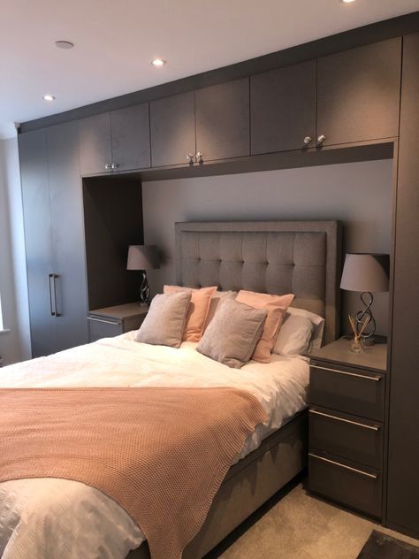 Are you looking for a fitted wardrobe that makes a statement? This is an anthracite linen finish that real does make a huge impact in this bedroom whilst creating plenty of storage space around the bed. Wardrobes Over The Bed, Modern His And Her Bedroom, Bed With Wardrobes Either Side Modern, Bedroom With Built In Wardrobe Around Bed, Bedroom Layout With Built In Wardrobe, Bed Beside Wardrobe, Master Bedrooms Decor With Storage, Wardrobe Beside Bed Small Spaces, Bed Wardrobe Design Modern