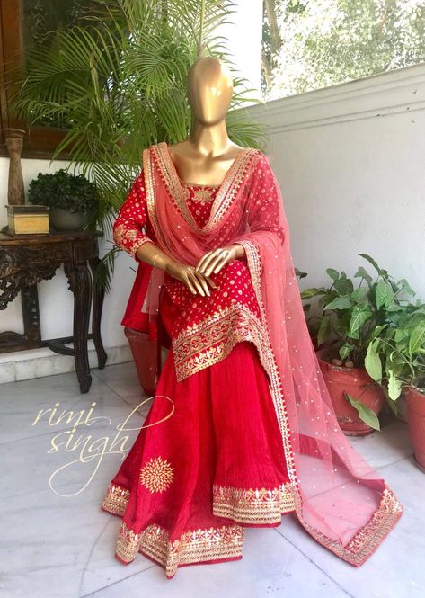 Red has more emotional associations than any other colour. Red is inherently exciting and naturally draws attention.  Red pure silk chanderi kurta with gold motifs, with gota and dabka hand embroidery on the neckline, sleeves and ghera , teamed with a matching crushed silk sharara with nakshi and gota border and a peach mukaish net dupatta with gota borders on four sides... Red Colour Sharara Design, Red Sharara Suit Bridal, Red Colour Dresses Indian, Red Colour Suit Design, Red Sharara Suit, Red Gharara, Sharara Style, Red Sharara, Silk Sharara