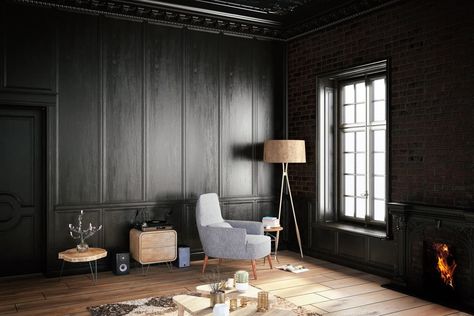 Dark living room with black full wainscoting and brick walls. It includes a gray chair lighted by a floor lamp over wood plank flooring. Dark Wood Paneling Walls, Wood Paneling Walls, Black Walls Living Room, Dark Wood Paneling, Black Room Design, Paneling Walls, Black Living, Dark Living Rooms, Black Rooms