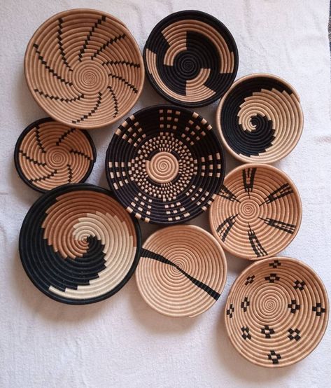 "Set of five 12\",10\" and 8\" brown, black and white African woven wall baskets. Rwandese wall baskets. Hanging Wall baskets.  Boho wall baskets / Wall baskets/ African wall decor/ African mats / Wall Decor mats / Kenyan baskets/ African wall baskets / sisal wall baskets. Fast Shipping via DHL Express (3-5days)." Woven Decor Living Rooms, African Wall Basket Decor, Kenyan Home Decor, African Baskets On Wall, Flat Baskets Wall Decor, Kenyan Baskets, Afro Boho Decor, African Basket Decor, Boho Wall Baskets