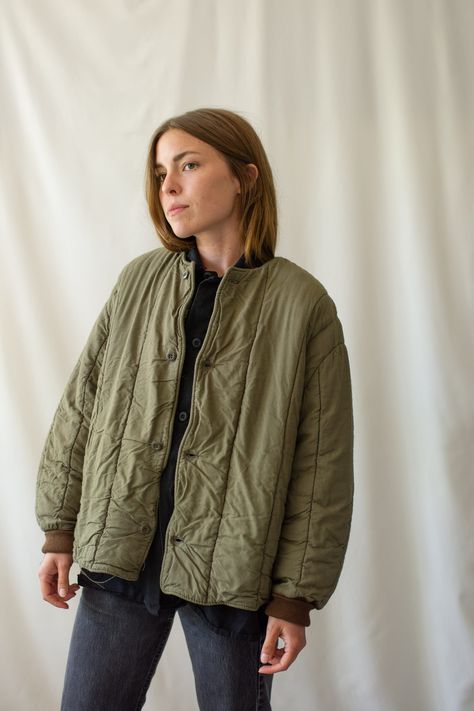 "Cotton quilted Olive green/ brown jacket with Four Buttons, Rounded shape, No Pockets, Brown Knit Cuff, Thick Quilted Cotton interior. Technically Reversible but there are only buttons on the face.  Please note that there are small openings at the pits. Absolute Favorite piece. SO Warm! Maker: European Military | Material: 100% Cotton Condition: Excellent. Washed Deadstock. Potential for small pin holes or small spot. MEDIUM/LARGE: Shoulders: 17\"  |  Chest: 23\"  |  Length: 25\"  |  Sleeve: 24 Olive Puffer Jacket Outfit, Puffer Jacket Outfit Women, Quilted Jacket Outfit, Crotch Boots, Puffer Jacket Outfit, Jacket Outfit Women, Jacket Puffer, Olive Green Jacket, Quilt Jacket