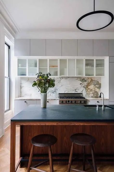 a stylish kitchen island with a black countertop - Shelterness Kitchen Counters And Backsplash, White Herringbone Tile Backsplash, Paonazzo Marble, White Shaker Style Kitchen, Townhouse Remodel, Glass Upper Cabinets, White Marble Backsplash, Soapstone Kitchen, White Herringbone Tile