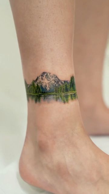 Forest Ankle Tattoo, Natural Tattoos For Women, Landscape Back Tattoo Women, Green Nature Tattoo, Forest Lake Tattoo, Detailed Mountain Tattoo, Nature Tattoos Color, Mountain Color Tattoo, Forest Tattoo Women