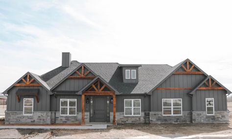 Grey And Black Farmhouse Exterior, Grey House Wood Beams Exterior, Slate House Exterior, Dark House With Light Stone, Dark Gray Siding Ranch House, Dark Siding Light Stone Exterior, Grey Stone House Exterior, Grey Brick House Exterior, Woodgrain Metal Siding