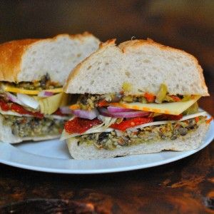 Meatless Muffalettas with mixed olive salad, mozzarella, provolone, pepper jack, red onion, artichoke hearts, and sundried tomatoes. Salad Mozzarella, Muffaletta Recipe, Muffaletta Sandwich, Olive Salad, Sundried Tomatoes, Veggie Burgers, Southern Food, Artichoke Hearts, Pepper Jack