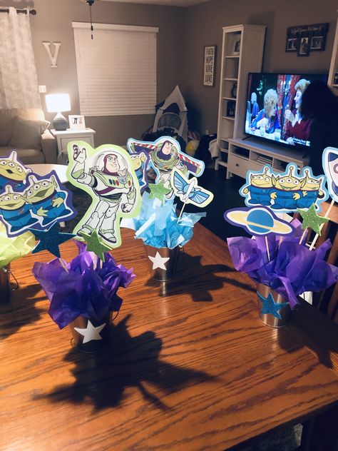 Buzz Lightyear party centerpieces Buzz Lightyear Centerpieces Party Ideas, Buzz Lightyear Table Centerpiece, Buzzlight Year Party Ideas, Buzz Light Year Centerpieces, Buzz Centerpiece, Diy 90th Birthday Decorations, Buzz Lightyear Centerpieces, Toy Story Table Centerpieces, Centerpieces For Birthday Party