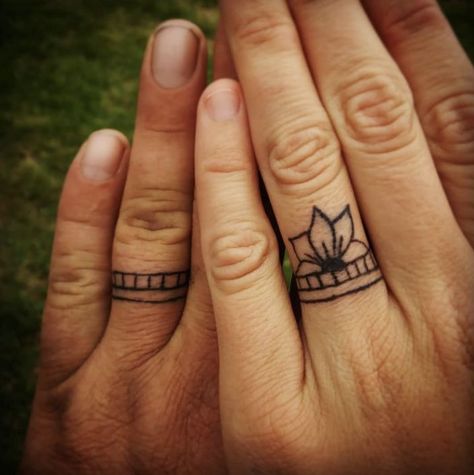 Couple Band Tattoos, Flower Ring Finger Tattoo, Sunflower Ring Tattoo, Finger Tattoos Wedding Ring, Matching Wedding Ring Tattoos, Floral Ring Tattoo, Matching Spouse Tattoos, Wedding Band Tattoo For Her, Ring Tattoo Designs Wedding