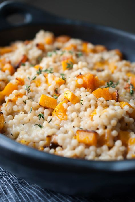 Cheesy Roasted Butternut Squash Couscous Casserole I used Israeli couscous in this dish because I love it’s shape and texture. I cooked it in coconut milk, mixed it in with the ghee roasted squash and piled on high the cheese. Obviously. Then it’s baked until melty and gooey. I mean, this dish is sinful and I absolutely love it. lifeisbutadish.com #butternutsquashsidedish #Israelicouscous Couscous Casserole, Butternut Squash Couscous, Butternut Squash Side Dish, Parmesan Roasted Potatoes, Popular Dinner Recipes, Cheesy Casserole, Couscous Recipes, Veggie Meals, Roasted Squash