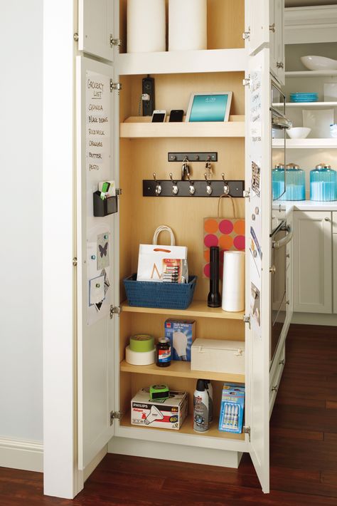 Grab and go! Our utility drop zone cabinet keeps everything you need to get out the door at the ready. #SchrockCabinets #MasterBrandCabinets Filing Cabinet Kitchen Cabinets, Broom Cabinet Kitchen, Hidden Drop Zone Kitchen, Utility Closet In Kitchen, Pull Out Utility Cabinet, Shallow Cabinet Storage, Drop Down Spice Cabinet, Drop Zone Cabinet, Kitchen Drop Zone