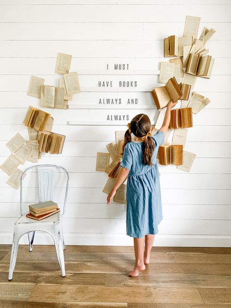 Today I am going to show you how I created this fun book wall around our Letter Board.     You will need: -Letter Board - Old Books (I used a mix of old paperbacks and some antique hardcover ones) -Double Sided Tape -Heavy Duty Command Strips -Stapler or Nail Gun (Optional)     I started by using double sided tape to attach single pages to the wall. The most important thing I found was to stagger the books and pages so that there were gaps here and there, otherwise it will look How To Make A Book Arch, Homeschool Photoshoot, Diy Book Wall, Wall Letter Board, Book Wall Decor, Diy Letter Board, Book Backdrop, Books Wall, Wall Letter