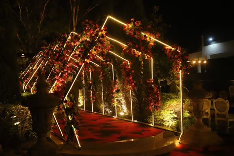 A customised entry porch created for a sangeet ceremony, decorated with led lights and flowers. Sangeet Entry Passage Decor, Sangeet Stage Decor With Led Screen, Sangeet Entry Decor, Passage Decor Wedding, Wedding Entry Decoration, Event Entry Gate Design, Wedding Stage Decorations Elegant Classy, Marriage Entry Gate Decoration, Sangeet Entrance Decor