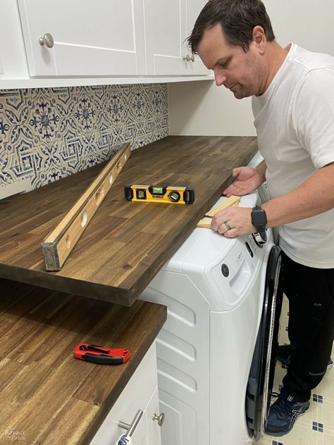 Butcher Board Laundry Room, Table Over Laundry Machine, Laundry Room Ideas Countertops, Laundry Room Sink Ideas Counter Tops, Laundry Room Ideas With Butcher Block, Diy Wood Counter Top Laundry Room, Wood Top Over Washer And Dryer, Hinged Countertop Laundry, Butcher Block Countertop In Laundry Room