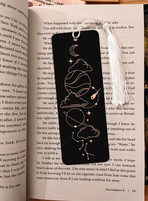 This beautiful bookmark is the perfect gift for any reader! The bookmark is made of metal and comes with a tassel. Keeping track of where you are in a book is more important than you think! Having to re-read or find where you left off can be frustrating. Mark where you ended with this super cute bookmark!  This bookmark boasts an intricate and mysterious design, with clouds and stars, a beautiful moon, and astrology symbols. The design is expertly printed using high-quality ink, ensuring that the colors stay vibrant and bright for years to come. Made with a durable and sturdy material, this bookmark will easily withstand the wear and tear of daily use. The slim design makes it easy to slip into any book, while the high-quality finish gives it a luxurious feel that will make it a joy to use Stars Bookmark, Booktok Bookmarks, Bookmark Design, Homemade Bookmarks, Star Bookmark, Handmade Bookmarks Diy, Astrology Stars, Bookmark Printing, Creative Bookmarks