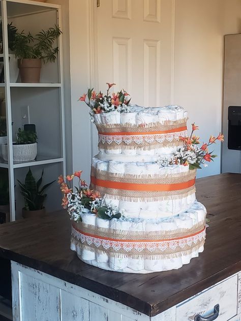 Daiper cake with orange flowers and burlap ribbon, topped with orange and white lace ribbon. Little Cutie Diaper Cake, Baby Shower Box, Citrus Baby, Cake Tower, Orange Theme, Orange Baby Shower, Baby Shower Diaper Cake, Beautiful Portraits, Fall Things