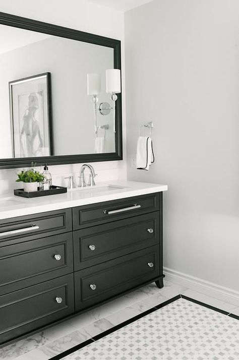 Various hardware accent a black double vanity- such in this, long horizontal chrome pulls and glass knobs mix well to contrast against a black finish. Chrome And Black Bathroom, Black Bathroom Fixtures, White Herringbone Tile, Black And White Tiles Bathroom, White Bathroom Vanity, Black White Bathrooms, Black Vanity Bathroom, Bathroom Accent Wall, Double Sinks